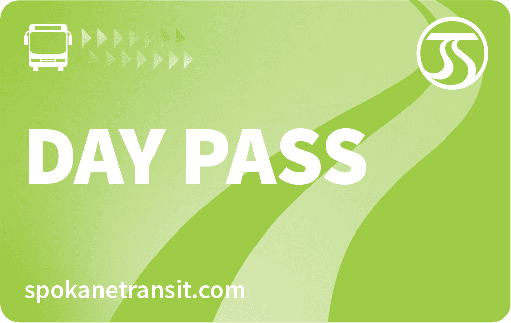 A green Spokane Transit day pass card featuring a bus icon, a series of small arrows, and the Spokane Transit logo in the top right corner is part of the STA Community Access Program. The text "DAY PASS" is prominently displayed, with "spokanetransit.com" at the bottom.