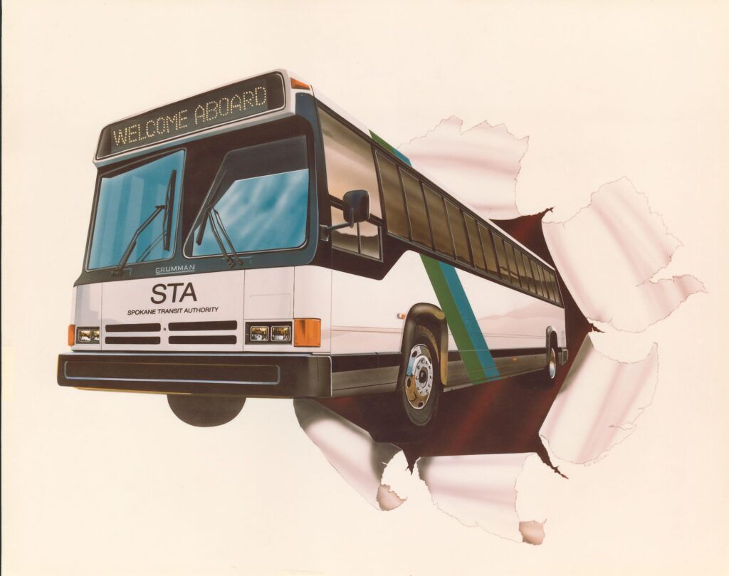 An STA bus with "Welcome Aboard" on display bursts through a paper wall, featuring the Spokane Transit Authority logo.